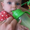 baby drinking breastmilk from sippy cup