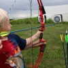 Little boy shooting bow and arrow